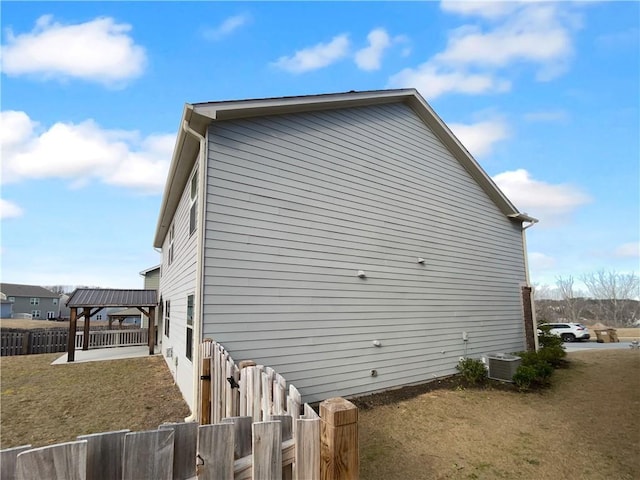 view of home's exterior with fence and central air condition unit