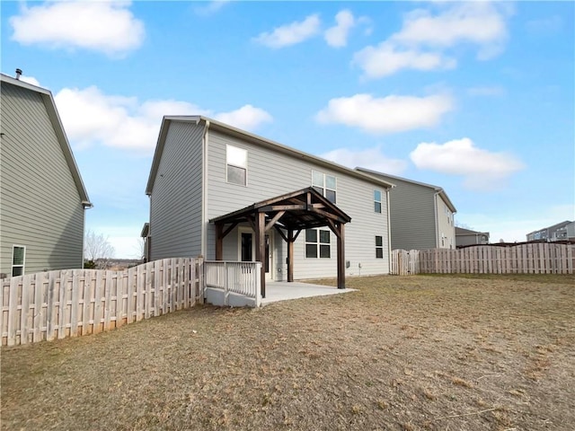 rear view of house with a patio area, a fenced backyard, and a gazebo