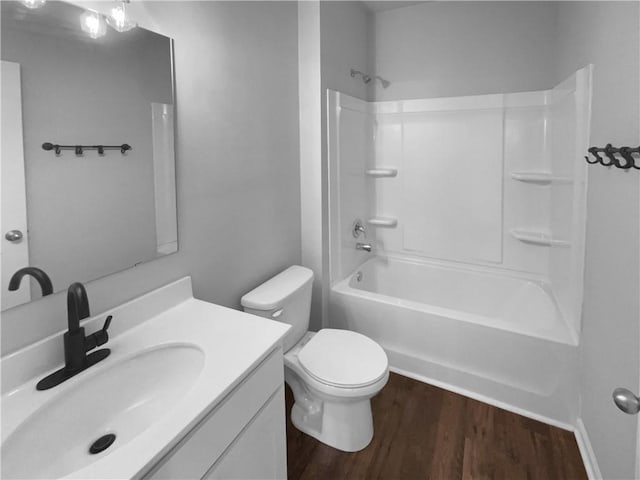 full bathroom with shower / bath combination, vanity, toilet, and wood finished floors