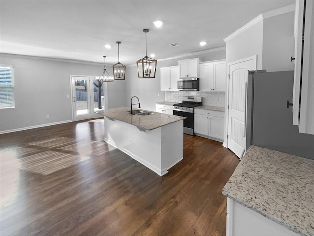 kitchen with stainless steel appliances, backsplash, plenty of natural light, and a sink