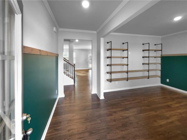 entrance foyer with crown molding, stairway, baseboards, and wood finished floors