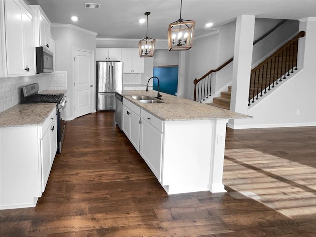 kitchen featuring stainless steel appliances, dark wood-style flooring, a sink, and ornamental molding