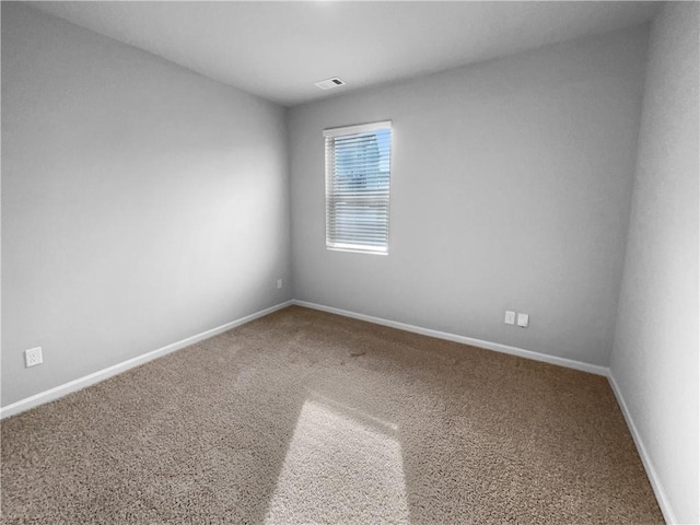 spare room with carpet flooring and baseboards