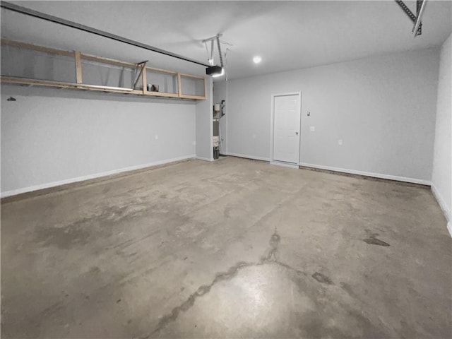 garage featuring baseboards and a garage door opener