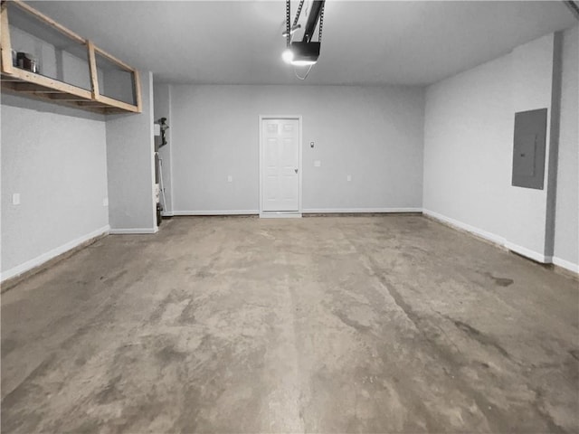 garage featuring electric panel and baseboards