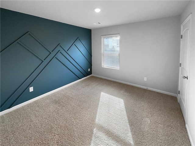 empty room with carpet floors and baseboards