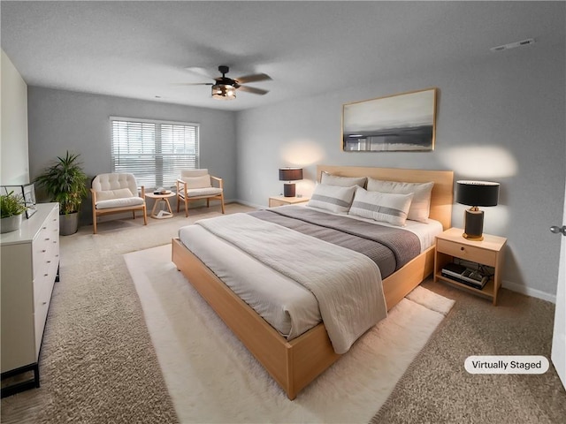 carpeted bedroom featuring visible vents, ceiling fan, and baseboards