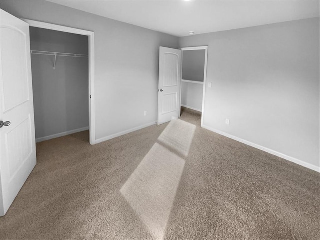 unfurnished bedroom with carpet floors, a closet, and baseboards