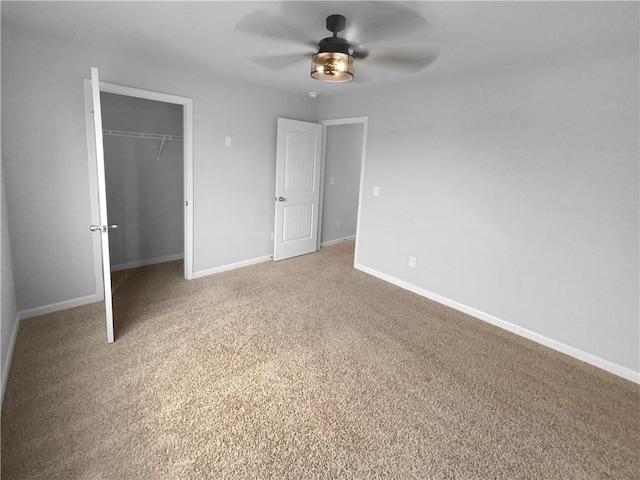 unfurnished bedroom featuring ceiling fan, a closet, light colored carpet, and baseboards