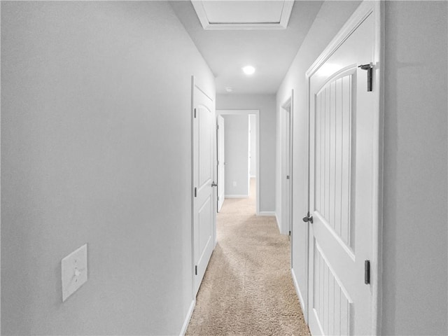 corridor with light colored carpet and baseboards