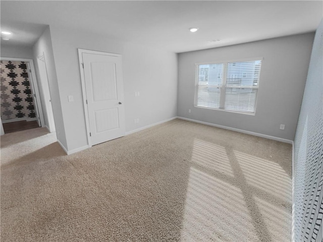 unfurnished room featuring baseboards and carpet flooring