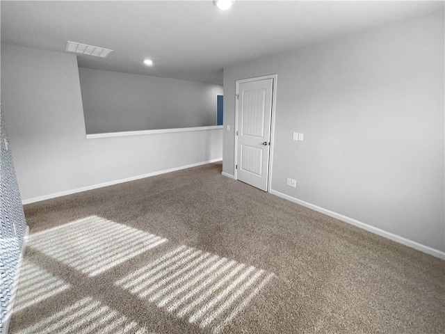 carpeted empty room with recessed lighting, visible vents, and baseboards