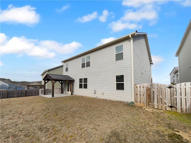 back of house featuring a gazebo, a lawn, a patio area, and fence