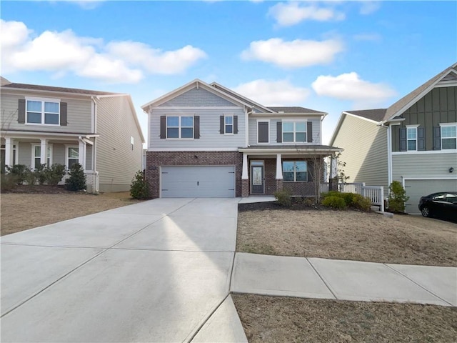 craftsman inspired home featuring a porch, brick siding, driveway, and an attached garage