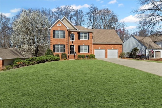 colonial inspired home with a front lawn, concrete driveway, brick siding, and an attached garage