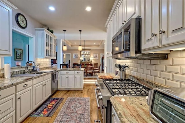 502 Cottage Crest Dr, Clarkesville, GA 30523 - kitchen featuring stainless steel appliances, light wood finished floors, glass insert cabinets, recessed lighting, and tasteful backsplash
