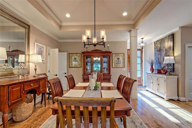502 Cottage Crest Dr, Clarkesville, GA 30523 - dining space with light wood-style flooring, a raised ceiling, a chandelier, crown molding, and recessed lighting