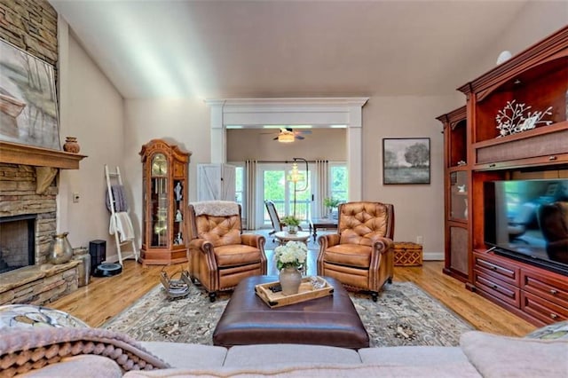 502 Cottage Crest Dr, Clarkesville, GA 30523 - living area featuring wood finished floors, a stone fireplace, and a ceiling fan