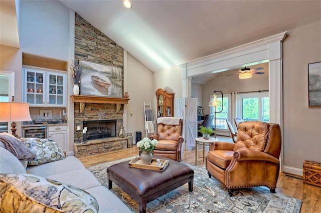 502 Cottage Crest Dr, Clarkesville, GA 30523 - living area featuring wood finished floors, baseboards, a fireplace, a ceiling fan, and high vaulted ceiling