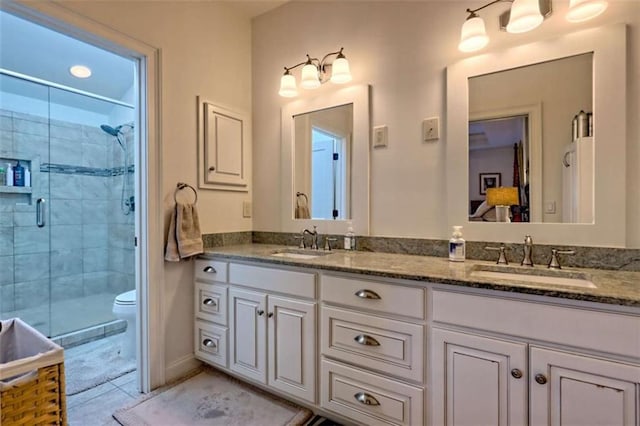 502 Cottage Crest Dr, Clarkesville, GA 30523 - full bathroom featuring double vanity, a shower stall, toilet, tile patterned flooring, and baseboards