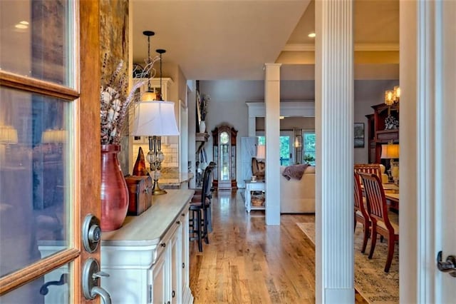 502 Cottage Crest Dr, Clarkesville, GA 30523 - foyer entrance featuring decorative columns, light wood-style floors, and ornamental molding