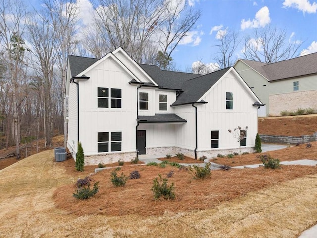 modern farmhouse style home with a shingled roof, board and batten siding, and cooling unit