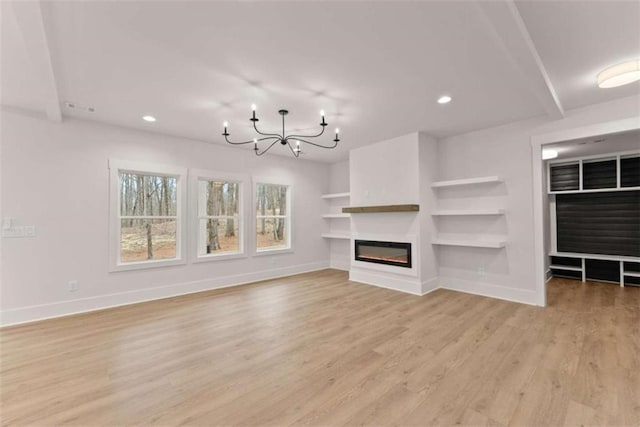 unfurnished living room with baseboards, a glass covered fireplace, light wood-style floors, a chandelier, and recessed lighting