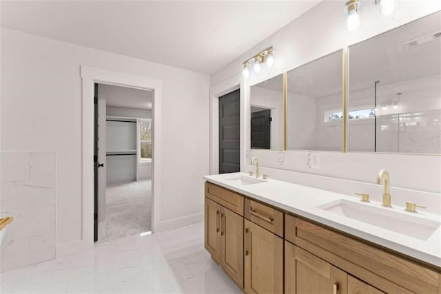 full bathroom with double vanity, marble finish floor, visible vents, and a sink