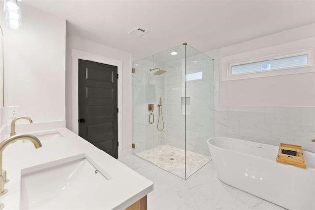 full bathroom featuring vanity, visible vents, marble finish floor, a soaking tub, and a marble finish shower