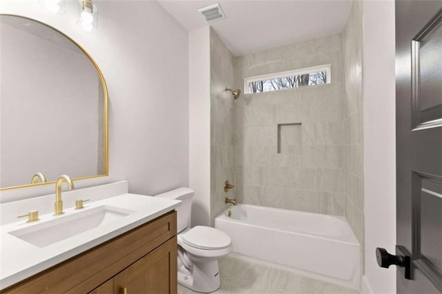 bathroom with visible vents, toilet, vanity, shower / tub combination, and tile patterned flooring