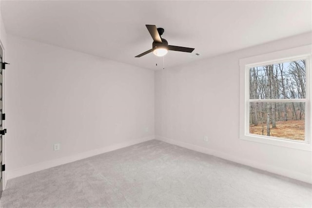 unfurnished room with carpet, ceiling fan, and baseboards