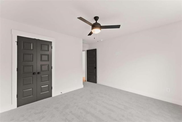 interior space with a ceiling fan and carpet