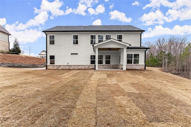 rear view of property featuring a lawn and a patio area