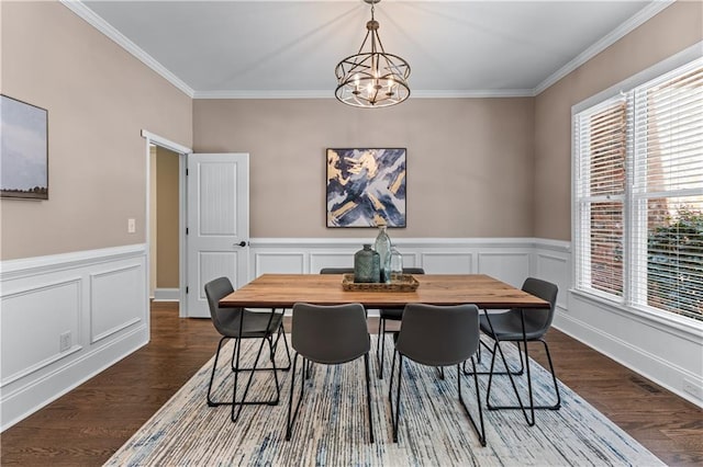 5765 Riley Rd, Cumming, GA 30028 - dining space featuring dark wood-style flooring, crown molding, a chandelier, a decorative wall, and wainscoting