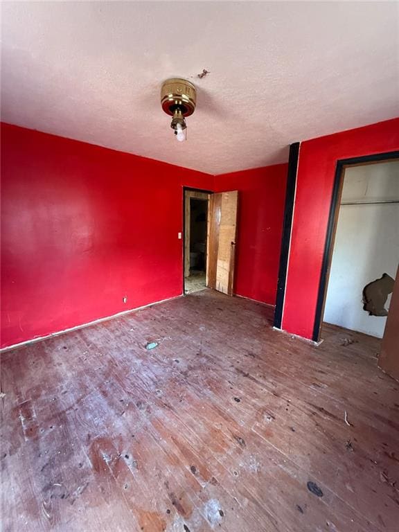 unfurnished bedroom with wood-type flooring and a closet