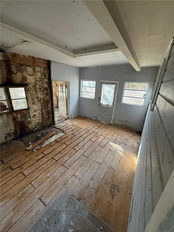 interior space with plenty of natural light and beamed ceiling