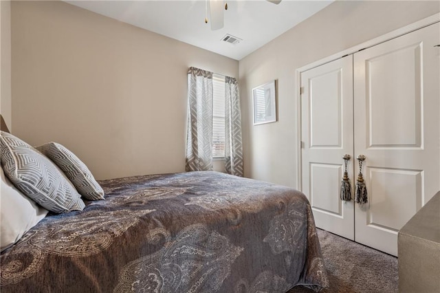 bedroom with a closet, carpet, visible vents, and ceiling fan