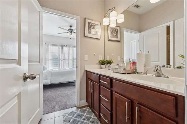 ensuite bathroom with double vanity, tile patterned floors, ensuite bath, and a sink