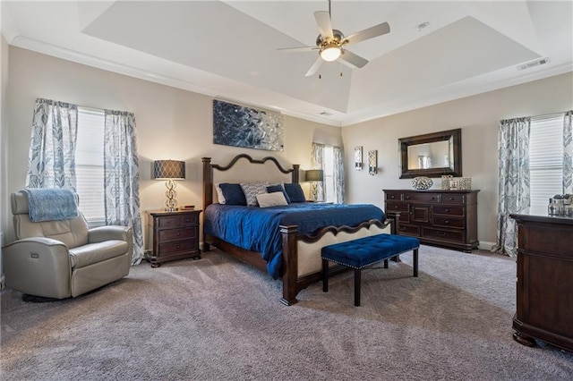 bedroom with visible vents, a raised ceiling, carpet, and ornamental molding