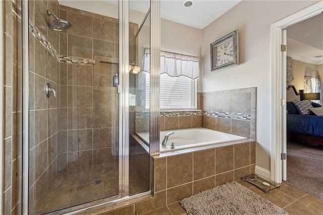 ensuite bathroom with tile patterned floors, connected bathroom, a garden tub, and a shower stall