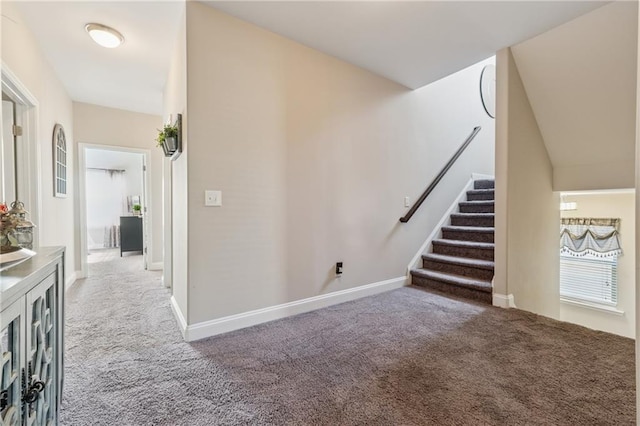 interior space with stairs, baseboards, and carpet flooring