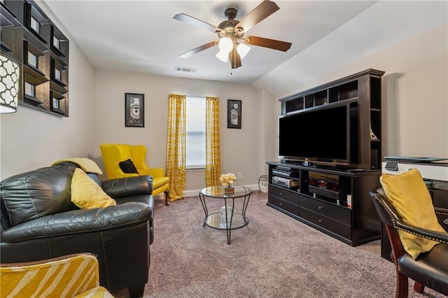 carpeted living room with visible vents, lofted ceiling, baseboards, and ceiling fan