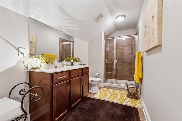 bathroom with visible vents, vanity, toilet, and a shower stall