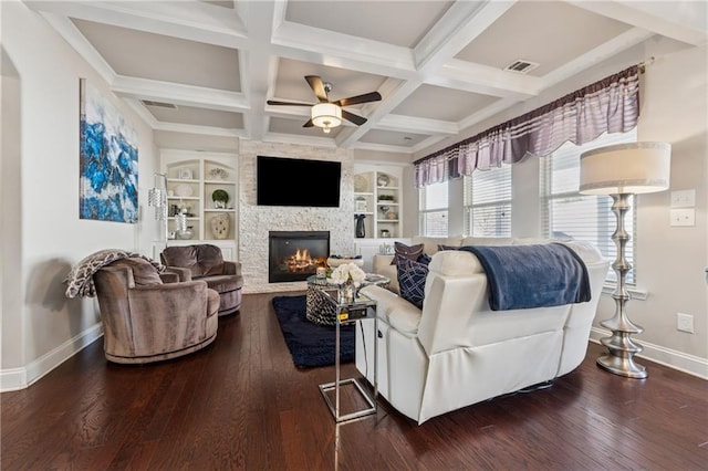 living room featuring a stone fireplace, coffered ceiling, baseboards, and hardwood / wood-style flooring