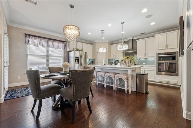 dining area with visible vents, ornamental molding, baseboards, a chandelier, and dark wood-style flooring