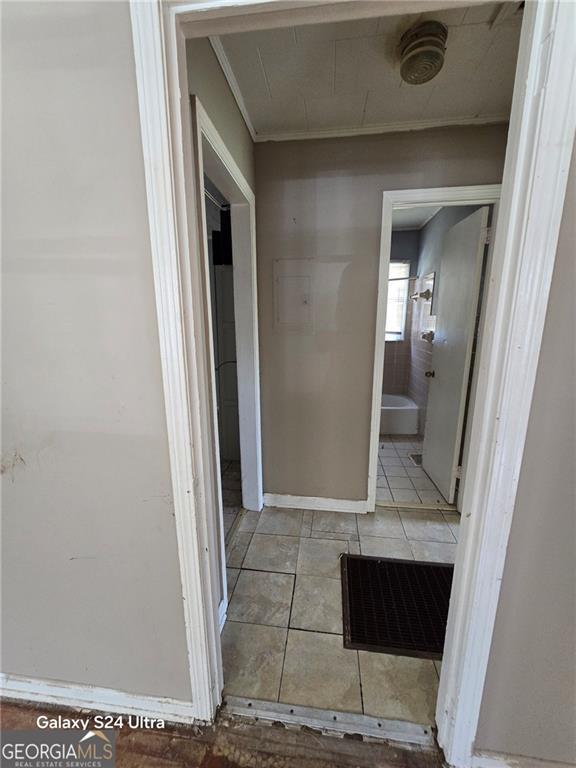 1243 Hill St NW, Conyers, GA 30012 - hall featuring tile patterned flooring and ornamental molding