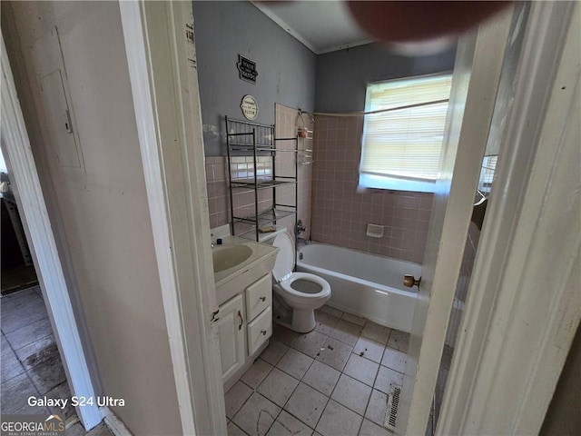 1243 Hill St NW, Conyers, GA 30012 - full bathroom with tile patterned floors, vanity, toilet, bathtub / shower combination, and tile walls