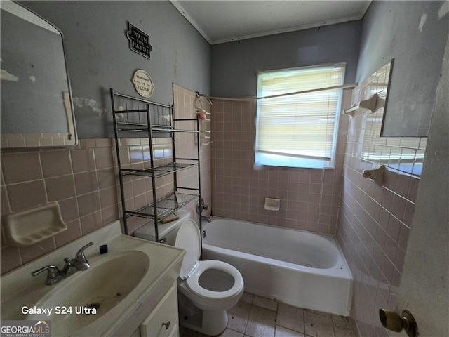 1243 Hill St NW, Conyers, GA 30012 - full bath with tile walls, toilet, tile patterned floors, vanity, and bathtub / shower combination
