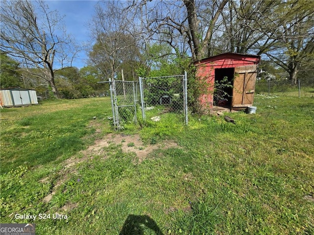 1243 Hill St NW, Conyers, GA 30012 - view of yard featuring a storage shed, an outbuilding, and a gate