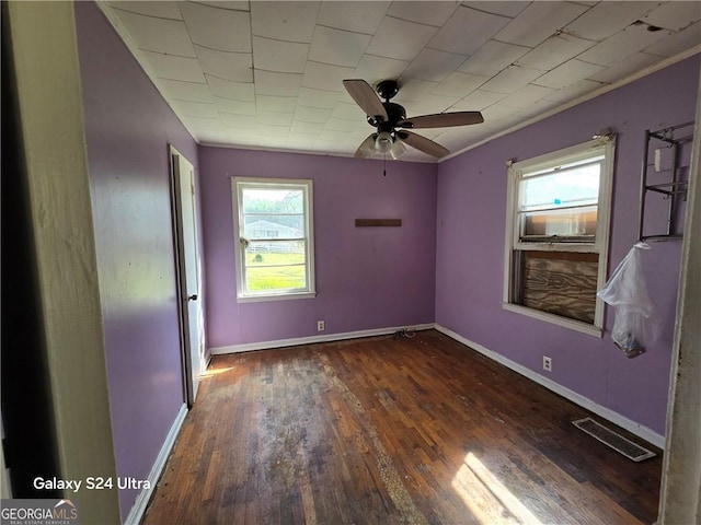 1243 Hill St NW, Conyers, GA 30012 - unfurnished room with plenty of natural light, hardwood / wood-style floors, crown molding, baseboards, and a ceiling fan